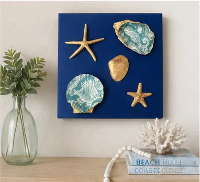 Shell wall art displayed above a console table