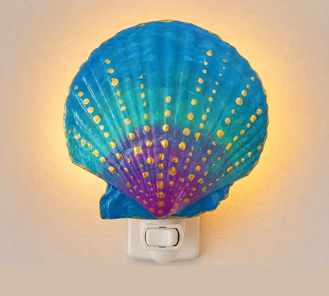 Mermaid Sunset shell night light glowing on a wall